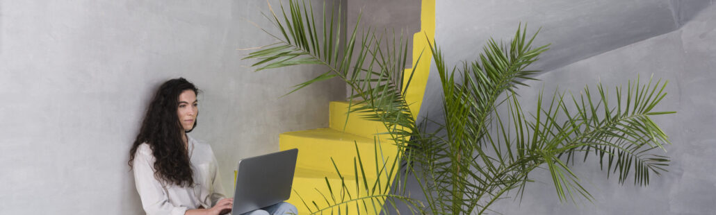 woman-sitting-stairs-using-laptop