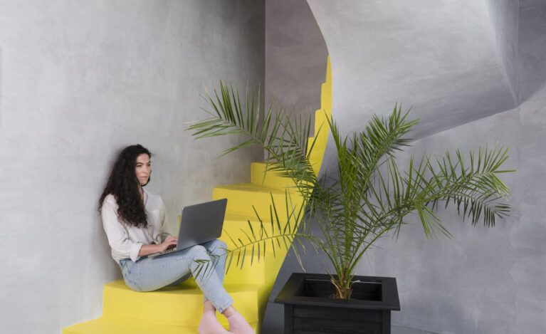 woman-sitting-stairs-using-laptop